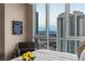 Bedroom offers a cityscape view from floor-to-ceiling windows and features a leather chair and golf ball display at 2877 Paradise Rd # 2602, Las Vegas, NV 89109