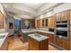 Open kitchen featuring a marble island, modern appliances, wood cabinets, and city views at 2877 Paradise Rd # 2602, Las Vegas, NV 89109