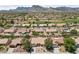 Stunning aerial view of the neighborhood with mountain views and well-maintained homes with desert landscaping at 2925 Lotus Hill Dr, Las Vegas, NV 89134