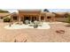 Well-maintained backyard showcasing a covered patio with elegant outdoor furniture and desert landscaping at 2925 Lotus Hill Dr, Las Vegas, NV 89134