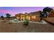A spacious backyard boasts a covered patio, desert landscaping, and mature trees at 2925 Lotus Hill Dr, Las Vegas, NV 89134