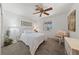 This bedroom has carpeted floor, a ceiling fan, window with a view of the outdoors, and a white wooden bed at 2925 Lotus Hill Dr, Las Vegas, NV 89134