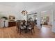 Elegant dining room with hardwood floors, a decorative chandelier, and a mirrored wall feature at 2925 Lotus Hill Dr, Las Vegas, NV 89134