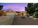 Single-story home featuring a low-maintenance desert landscape with a two-car garage at 2925 Lotus Hill Dr, Las Vegas, NV 89134