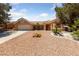 This home has desert landscaping, a terra cotta colored tile roof, and an attached garage at 2925 Lotus Hill Dr, Las Vegas, NV 89134