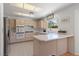 Functional kitchen with white appliances, ample counter space, and a window overlooking the garden at 2925 Lotus Hill Dr, Las Vegas, NV 89134