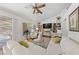 Bright living room featuring vaulted ceilings, built-in shelving, and comfortable white furnishings at 2925 Lotus Hill Dr, Las Vegas, NV 89134