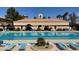 Relaxing outdoor pool area with sun loungers, a seating area, and lush landscaping at 2925 Lotus Hill Dr, Las Vegas, NV 89134