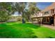 Expansive backyard featuring well-maintained lawn and mature trees, perfect for outdoor activities and relaxation at 3141 E Katie Ave, Las Vegas, NV 89121
