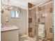 A bathroom featuring a glass enclosed shower, vanity and sink, and a window for natural light at 3141 E Katie Ave, Las Vegas, NV 89121