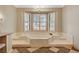 Bright bathroom featuring a marble-lined tub with shutters for natural light and checkerboard tile at 3141 E Katie Ave, Las Vegas, NV 89121