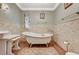 Elegant bathroom featuring a freestanding tub, decorative tile, and vintage fixtures at 3141 E Katie Ave, Las Vegas, NV 89121
