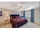 Well-lit bedroom featuring a large bed, accent chair, and a view of the outdoors at 3141 E Katie Ave, Las Vegas, NV 89121