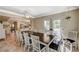 The dining room showcases a large wooden table with seating for eight, next to an open kitchen at 3141 E Katie Ave, Las Vegas, NV 89121