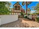 Charming home exterior with Tudor detailing, brick accents, and a beautiful private courtyard at 3141 E Katie Ave, Las Vegas, NV 89121
