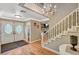 Grand foyer with chandelier, staircase, and elegant double entry doors at 3141 E Katie Ave, Las Vegas, NV 89121