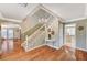 Elegant foyer with hardwood floors, staircase, chandelier and a partial view of the kitchen at 3141 E Katie Ave, Las Vegas, NV 89121