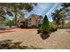 Charming Tudor-style home with brick chimney and lush landscaping and brick driveway at 3141 E Katie Ave, Las Vegas, NV 89121