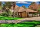 View of the charming Tudor-style home with attached garage and lush green lawn at 3141 E Katie Ave, Las Vegas, NV 89121