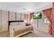 Comfortable primary bedroom with a floral bedding, television, and custom window treatments at 3141 E Katie Ave, Las Vegas, NV 89121