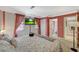 Inviting main bedroom with ensuite bathroom, television, and view of the backyard at 3141 E Katie Ave, Las Vegas, NV 89121