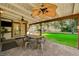 Covered outdoor patio area with seating, outdoor ceiling fans, and view of the backyard at 3141 E Katie Ave, Las Vegas, NV 89121