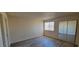 Bedroom featuring wood-look flooring, a window with blinds, and a mirrored closet at 3151 Soaring Gulls Dr # 2058, Las Vegas, NV 89128