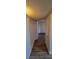 Hallway with wood-look vinyl flooring and white walls leading to an adjoining room at 3151 Soaring Gulls Dr # 2058, Las Vegas, NV 89128