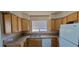 Kitchen with light wood cabinets, neutral countertops, double sink, and white appliances at 3151 Soaring Gulls Dr # 2058, Las Vegas, NV 89128