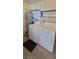 Laundry room featuring a white washer and dryer with metal shelving and water heater at 3151 Soaring Gulls Dr # 2058, Las Vegas, NV 89128