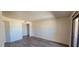 Open living space featuring wood-look flooring, white walls, closet and a sliding door to exterior at 3151 Soaring Gulls Dr # 2058, Las Vegas, NV 89128