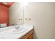 Powder room features a modern vanity, sink, large mirror, and a vibrant accent wall at 3464 Twilight Star Dr, Las Vegas, NV 89117