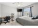 Bright bedroom features a ceiling fan, work desk, and a window with privacy blinds at 3464 Twilight Star Dr, Las Vegas, NV 89117