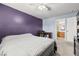 Spacious bedroom with purple accent wall, carpet floors, ceiling fan, and an en-suite bathroom at 3464 Twilight Star Dr, Las Vegas, NV 89117