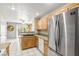 Modern kitchen features stainless steel refrigerator, dishwasher, granite counters, and wood cabinetry at 3464 Twilight Star Dr, Las Vegas, NV 89117