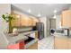 Well-lit kitchen with modern appliances, granite counters, and tile flooring at 3464 Twilight Star Dr, Las Vegas, NV 89117