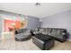 Spacious living room featuring tile floors and a cozy seating arrangement near the stairs at 3464 Twilight Star Dr, Las Vegas, NV 89117