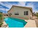 Backyard pool surrounded by serene landscaping, creating a private oasis for relaxation and enjoyment at 3539 Barrel Bronco Ct, North Las Vegas, NV 89032