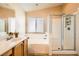 Well-lit bathroom featuring a soaking tub and a separate shower with a glass door at 3539 Barrel Bronco Ct, North Las Vegas, NV 89032