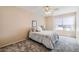 Cozy bedroom with plush carpeting, ceiling fan, and natural light from a window at 3539 Barrel Bronco Ct, North Las Vegas, NV 89032