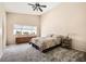 Serene bedroom with plush carpeting, a ceiling fan, and generous natural light at 3539 Barrel Bronco Ct, North Las Vegas, NV 89032