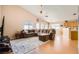 Spacious living room with vaulted ceilings and wood-look flooring offers a modern aesthetic at 3539 Barrel Bronco Ct, North Las Vegas, NV 89032