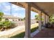 Covered patio and backyard with neutral colored walls, a block fence and desert landscaping at 3646 Billman Ave, Las Vegas, NV 89121