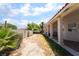 Backyard featuring desert landscaping, a covered patio, block fence, and native foliage at 3646 Billman Ave, Las Vegas, NV 89121