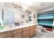Bathroom with a double vanity, tiled floors, and accessible shower and toilet features at 3646 Billman Ave, Las Vegas, NV 89121