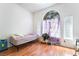 Bright bedroom featuring hardwood floors, a large arched window, and neutral walls at 3646 Billman Ave, Las Vegas, NV 89121