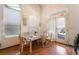 Dining area featuring large windows, laminate flooring, and table setting at 3646 Billman Ave, Las Vegas, NV 89121
