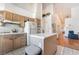 Bright kitchen featuring white appliances, tile countertops, and light wood cabinets at 3646 Billman Ave, Las Vegas, NV 89121
