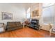 Living room featuring fireplace, large windows, and laminate flooring at 3646 Billman Ave, Las Vegas, NV 89121