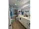 Bright bathroom features a double sink vanity, tiled floors, and a shower-tub combo with tiled walls at 3854 Chutney St, Las Vegas, NV 89121